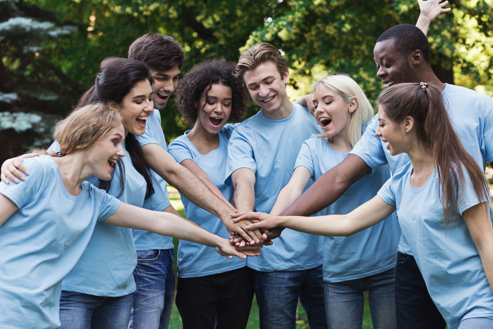 Happy,Young,Diverse,Volunteers,Preparing,For,Work,,Join,Hands,In